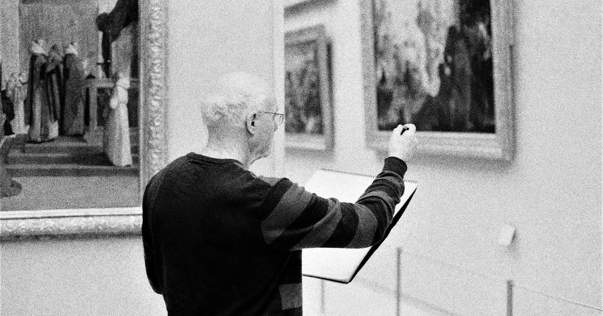 Researcher examining a label on the back of a framed painting